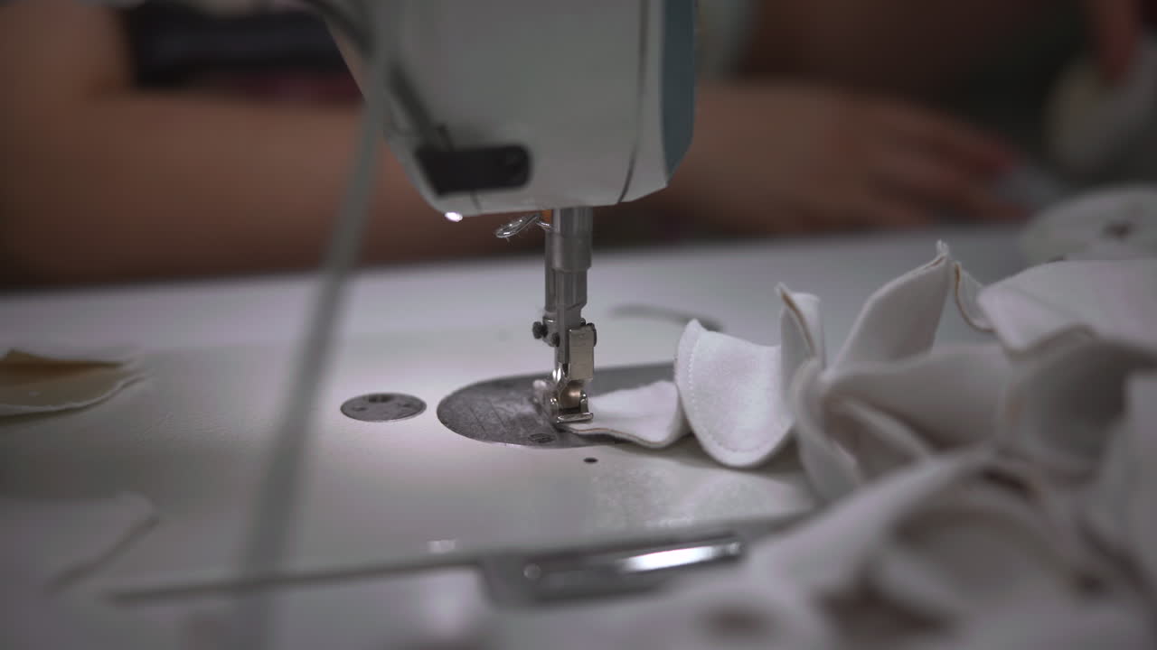 Closeup Sewing Foot Stitching White Fabric. Needle And Presser Foot Work Together To Form Neat Seam, Operator. Media