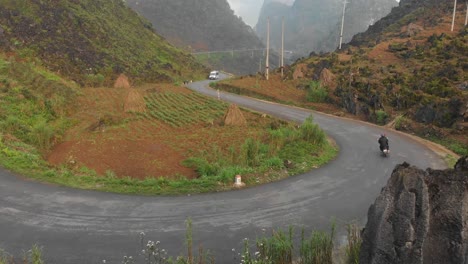 close up shot of motorbike passing by on ma pi leng pass, aerial