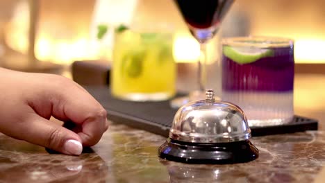 hand ringing bell at bar counter