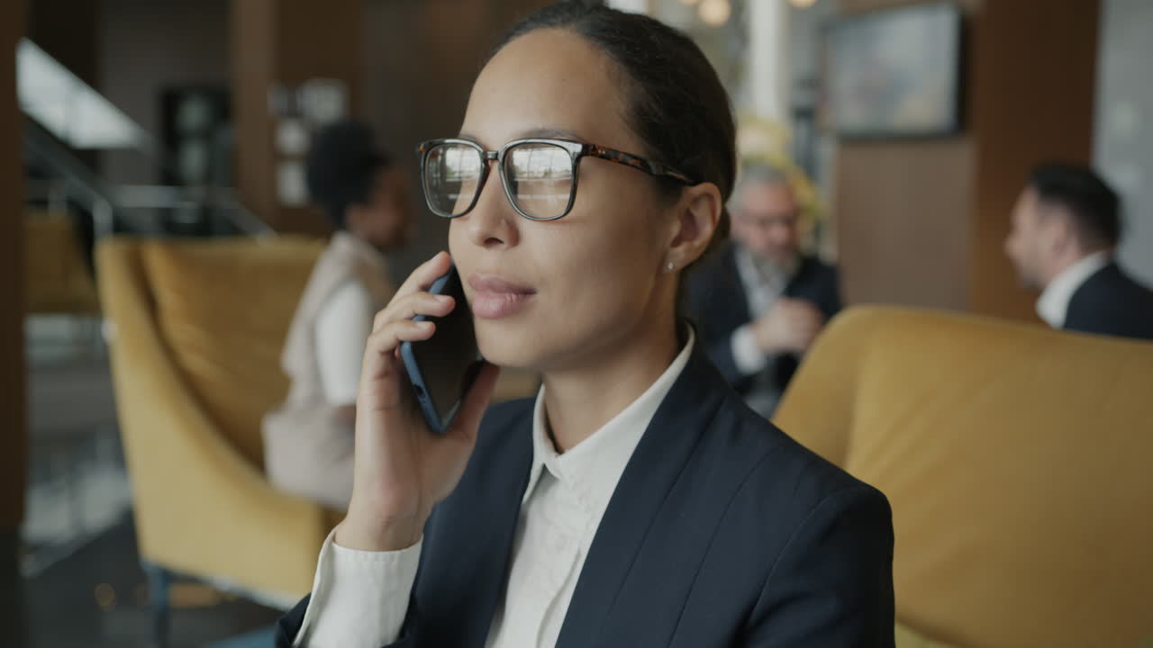 Businesswoman on Phone in Office Lobby