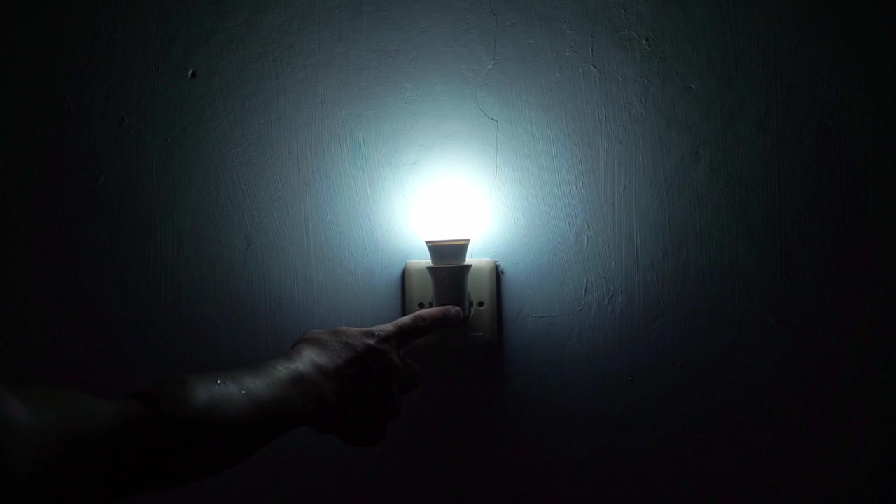 Wall light being switched off in dark room, perfect for electricity, home interior, energy saving, and illumination themes.