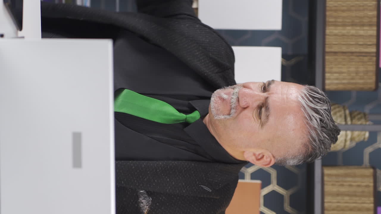 신경 ⁇ 약을 겪고 있는 사업가의 수직 영상입니다.