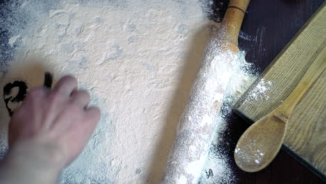 inscription bakery on white flour spills on the kitchen table. bakery concept