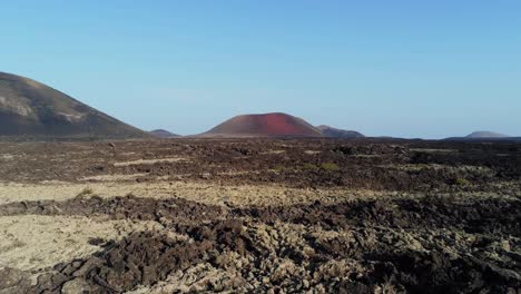 volcanic landscape of lanzarote island with rough terrain, aerial drone view