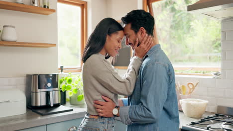 Hug,-happy-and-couple-in-a-kitchen-bonding
