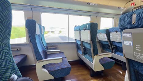 Empty-seats-on-the-Nampu-Service-Limited-Express-train-traveling-on-JR-Shikoku-through-the-mountainous-Japanese-island-from-Kochi-to-Okayama,-passing-through-the-countryside-and-nature-destinations