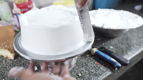 close up of professional chef squeezes cream and makes cake base 4k