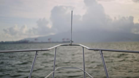 a smooth b-roll shot captures the yacht's bow cutting through the waves, offering a stunning view of the endless ocean.