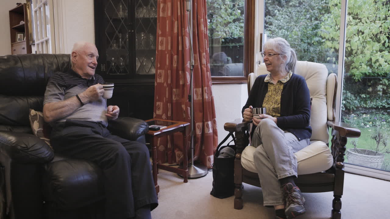 Elderly couple chatting in their living room