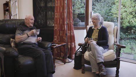 elderly couple chatting in their living room