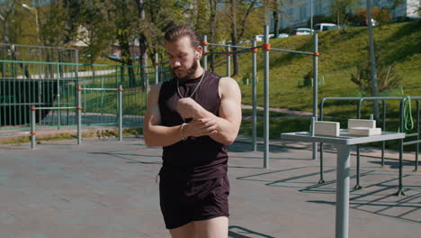 athletic lebanese man in sportswear stretching body and warm up before cardio workout exercises