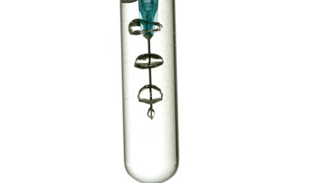 syringe blowing bubbles in test tube of water