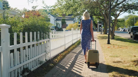 Woman-With-Suitcase-Walking-Down-Street