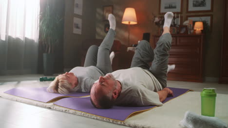 senior couple doing exercises at home