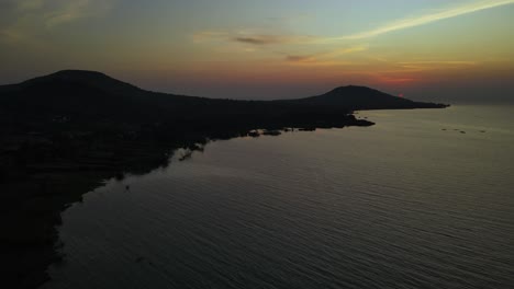 aerial establishing shot of the sunsetting over the lake victoria