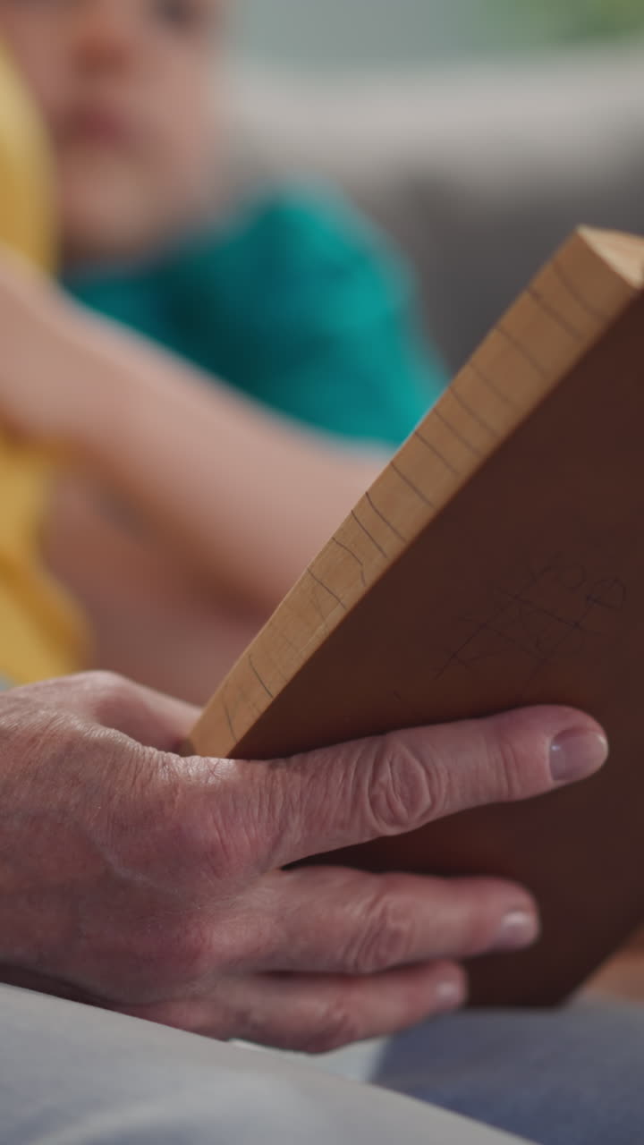 grandmother reads an old book to kids, a close-up book, a home library, slow motion