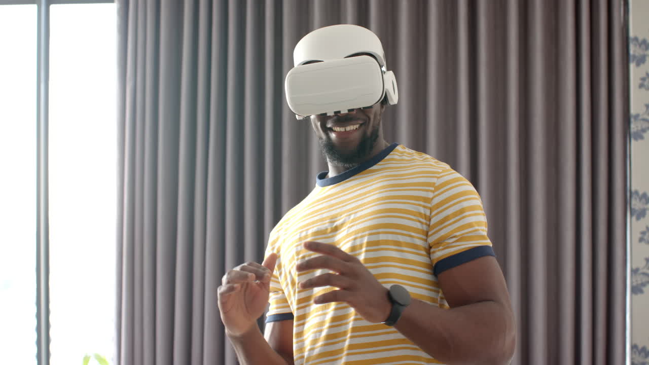 Wearing VR headset, man enjoying virtual reality experience at home
