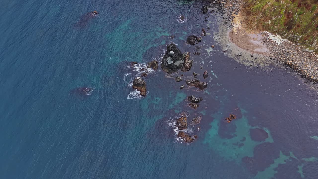 Coastline view showing rocks and clear water near a shore
