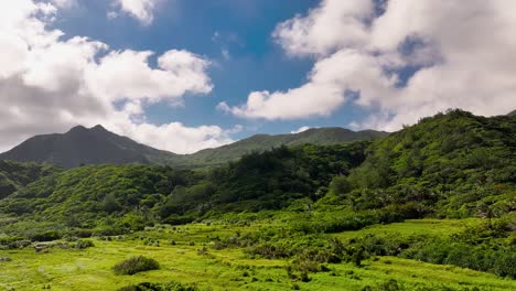 epic drone flight over exotic mountain landscape with summit and moving clouds at blue sky - orchid island, taiwan