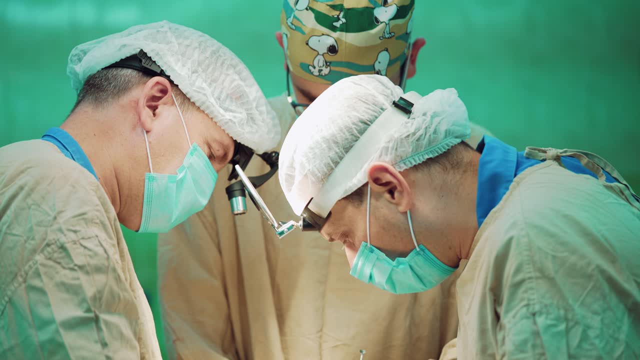 Medical team performing operation. Group of surgeon at work in operating theatre