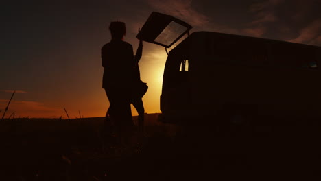 Road-trip,-sunset-and-silhouette-of-people-in-car