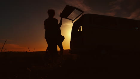 road trip, sunset and silhouette of people in car