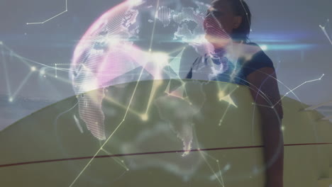 Senior surfer holding surfboard on beach, presenting holographic globe with network lines for tech