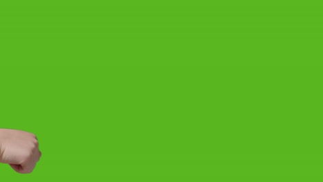 Close-Up-Of-Two-Young-Children-Giving-Each-Other-Fist-Bump-Against-Green-Screen