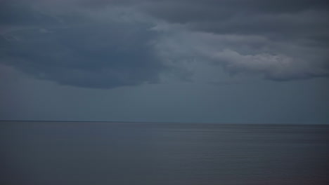 dreary ocean cloudscape time lapse at dawn with a stormy, overcast sky