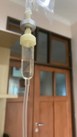 iv bag drip intravenous medication for hospital use with patient room background