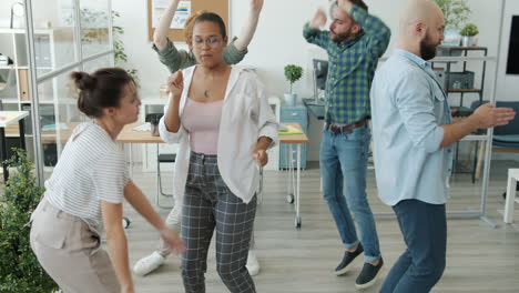 happy office team dancing