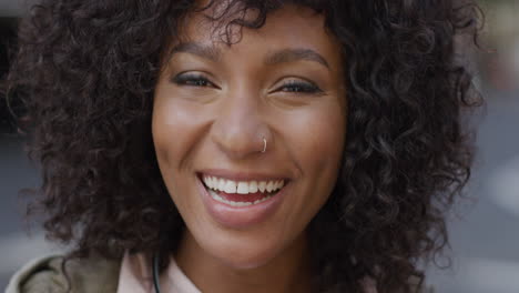 portrait happy african american woman smiling in city