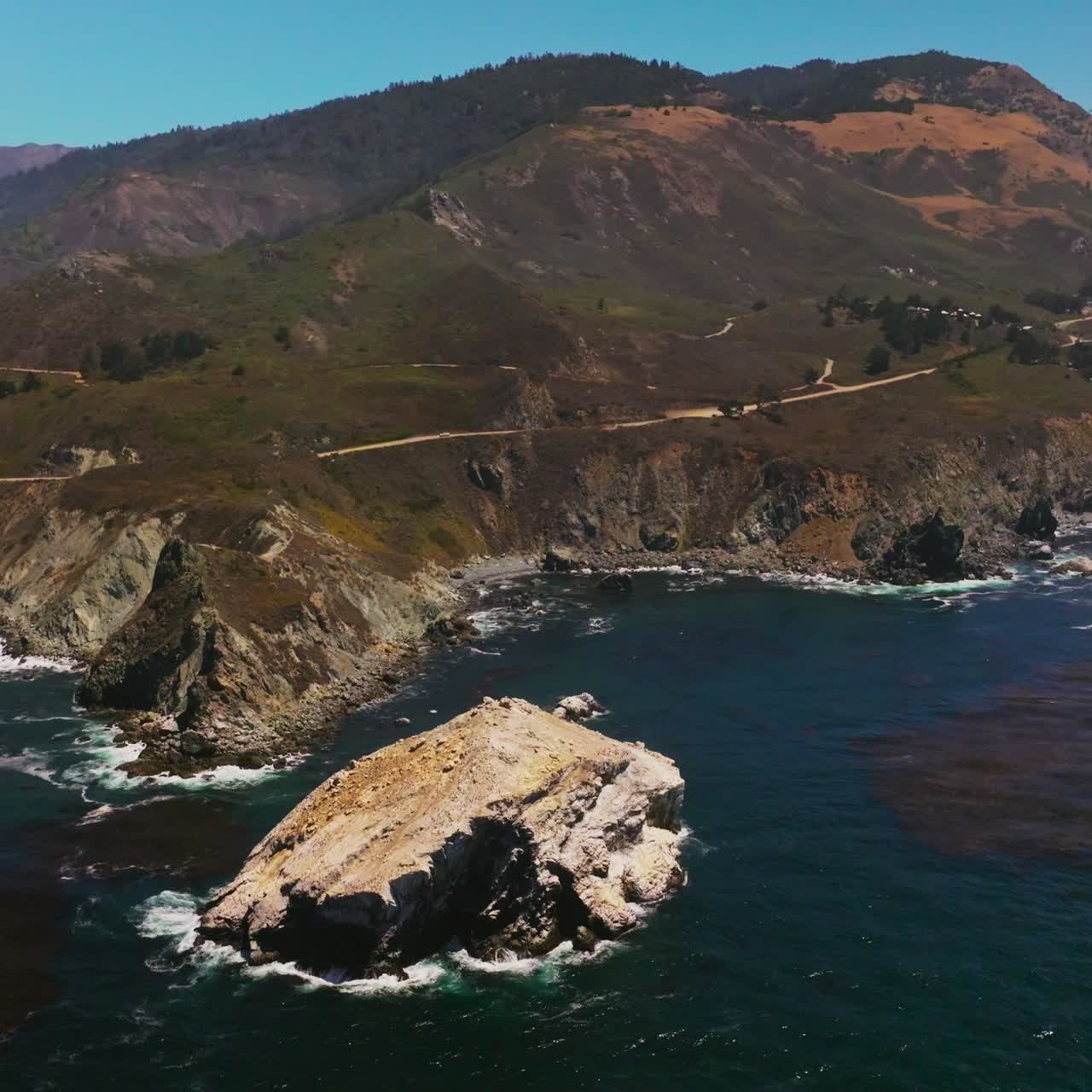 California scenery of seascape. The Pacific Ocean batters the rugged shore