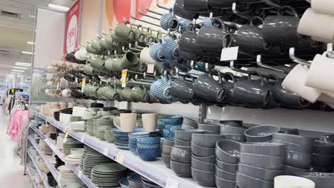 various mugs and cups displayed on shelves