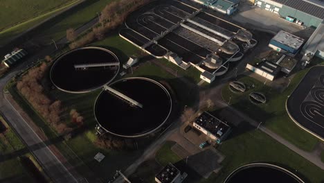 aerial view of a water treatment reservoir in the netherlands showing the various circular and rectangular forms of the water tanks of the facility