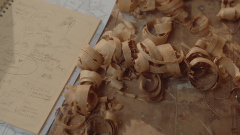 wood shavings and furniture sketches on workbench