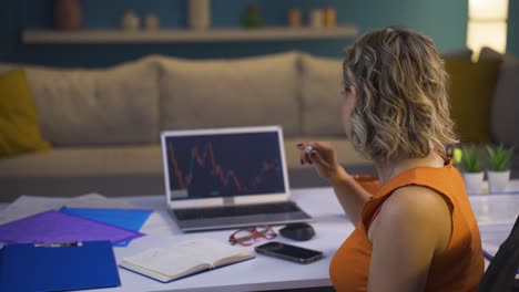 Woman-examining-and-thinking-financial-chart.