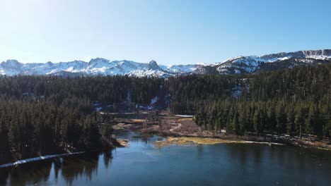 Drone-Flying-Towards-Snowy-Mountains-Over-Alpine-Lakes-in-Mammoth-Lakes-California