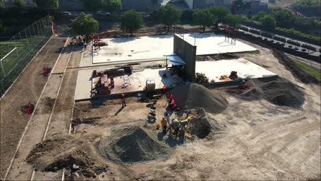 Drone-round-view-of-construction-workers-in-building-a-city-park-in-Mexico