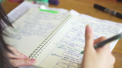 student studying and taking notes in a notebook