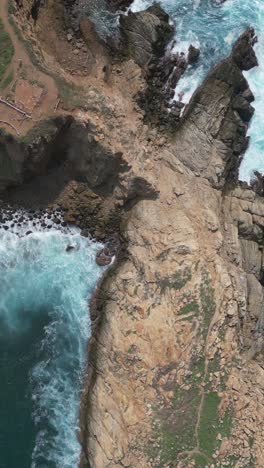 Vertical-aerial-shot-of-cliffs-and-rocks-at-Punta-Cometa,-Mazunte,-Oaxaca