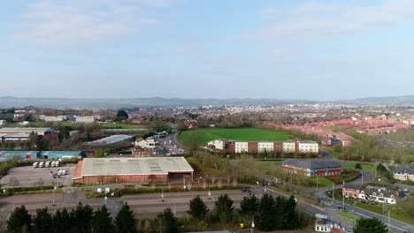 aerial tracking from left to right looking across the edge of sowton business estate and in the distance, exeter city centre