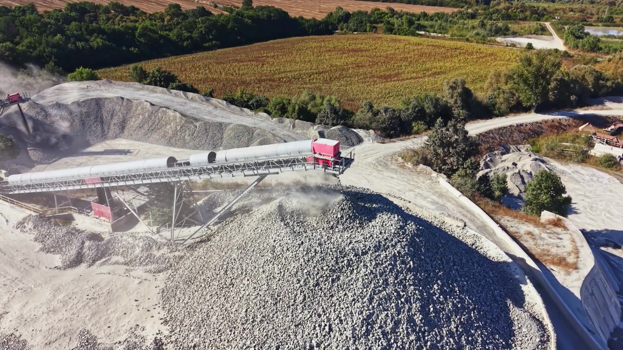 Granite quarry operations in a rural area with machinery and stockpiles visible