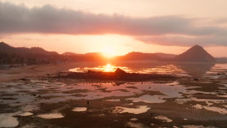 The-dry-reef-of-Kuta-Lombok-during-sunrise,-with-local-people-looking-for-food-and-seashells