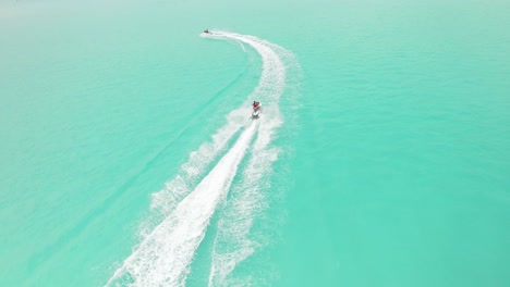 tourists go jetskiing in maldives