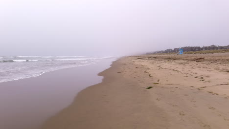 pajaro dunes beach in central california on a foggy, misty day - low altitude flyover