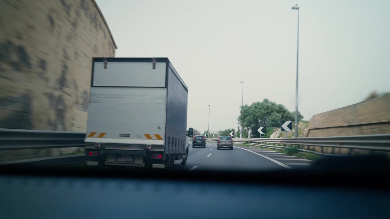 POV of a car exiting a tunnel onto a coastal highway in Sicily, perfect for travel or road-trip content.