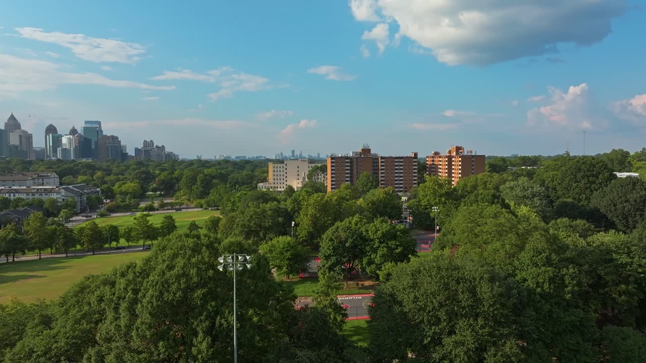 Urban green park with Atlanta city skyline buildings in distance, Central Park, Georgia, Drone
