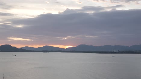 Beautiful-sunset-view-over-the-mountain-range-over-the-sea-bay-of-phuket-island-in-summer-daytime