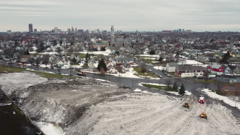 bulldozers plowing snow at the snow dump after winter storm in buffalo, new york, usa